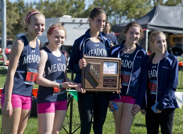 Ellen Hirsberg, center, of The Meadows School poses with the rest of her team after winning ...