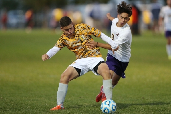 Durango&lsquo;s Jaime Munguia (9) fights for possession of the ball against Bonanza&lsquo;s ...