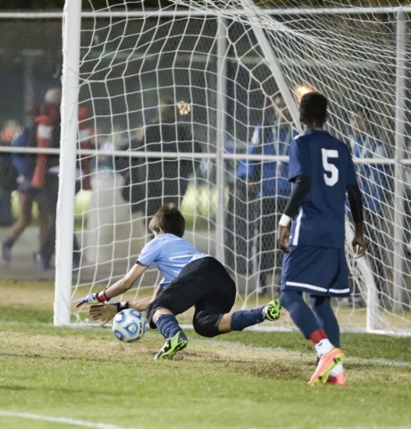 Foothill‘s Ricky Glogart (GK) makes a save as Becca Nyonyintono (5) watch‘s dur ...