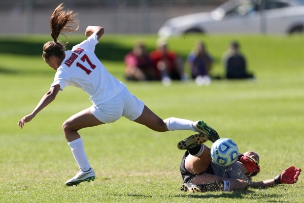 Arbor View‘s Deja Erickson (17) is stopped on her path to the goal against Centennial ...