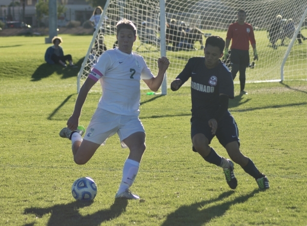 Green Valley‘s Antonio Trama (7) attempts to work the ball around Coronado‘s Nic ...