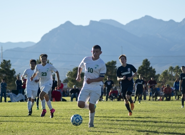 Green Valley‘s Connor Malone (10) takes the ball up the field during the Sunrise Regio ...