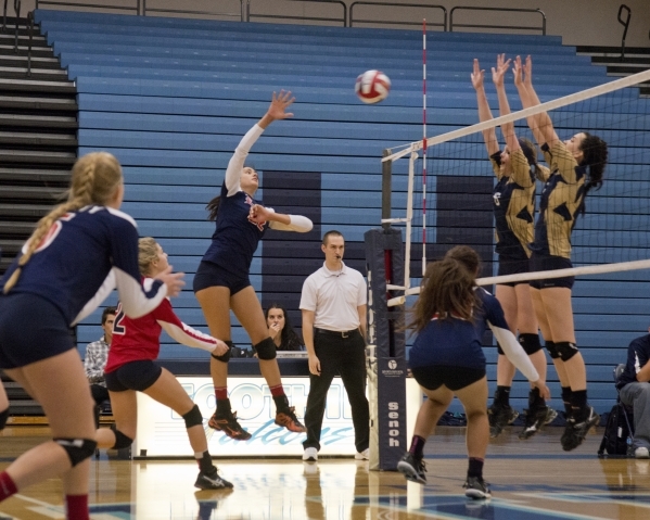 Liberty‘s Tiffany Watkins (22) hits the ball over the net during the Sunrise Region gi ...