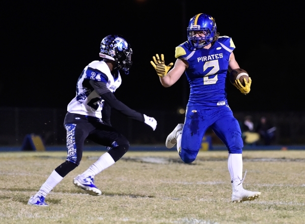 Moapa Valley‘s Trystin Deal runs with the ball against Desert Pines‘ Artise McCo ...