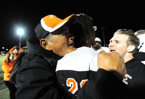 Chaparral head coach Paul Nihipali, left, hugs running back Richard Nelson after they upset ...