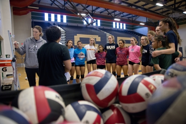 Players on the Shadow Ridge girls volleyball team receive instructions from coaches during p ...