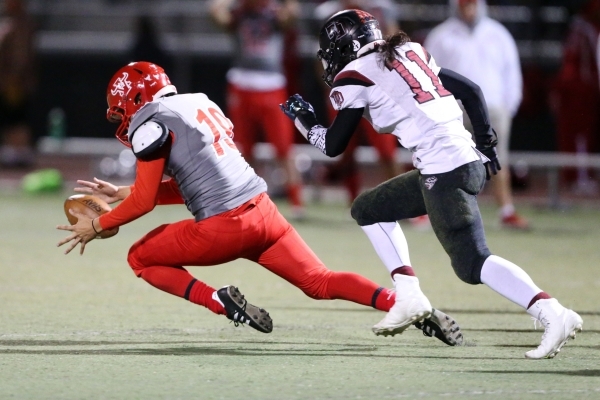 Arbor View‘s Carter Andrade (19) recovers his blocked kick against Desert Oasis in the ...