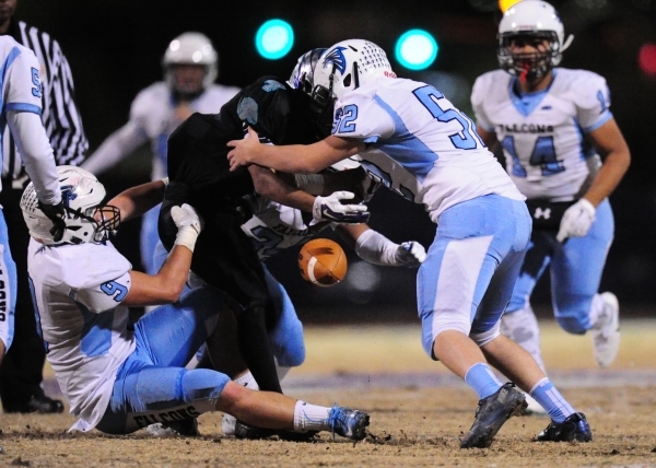 Silverado running back Seth Georgelos, middle, fumbles a punt return as Foothill defensive t ...