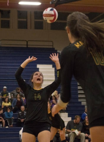 Bishop Manogue‘s Mikaela DeRicco (14) sets the ball during the Division I state semifi ...