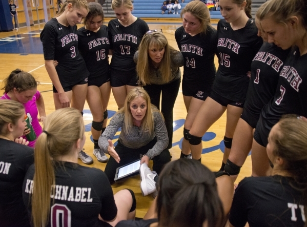 Faith Lutheran listens to their coaches during the Division I-A state volleyball final again ...