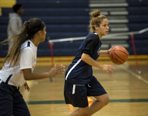 Essence Booker runs with the ball during basketball practice at Spring Valley High School in ...