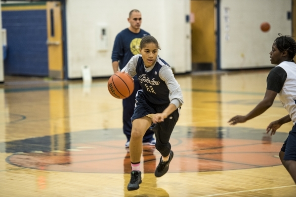 Kayla Harris runs with the ball during basketball practice at Spring Valley High School in L ...