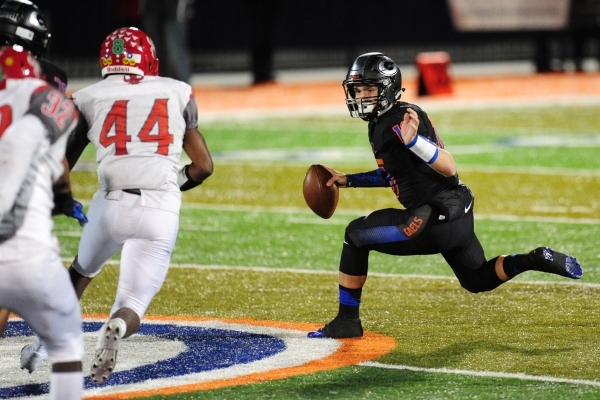 Bishop Gorman quarterback Tate Martell (18) scrambles while being chased by Arbor View tight ...
