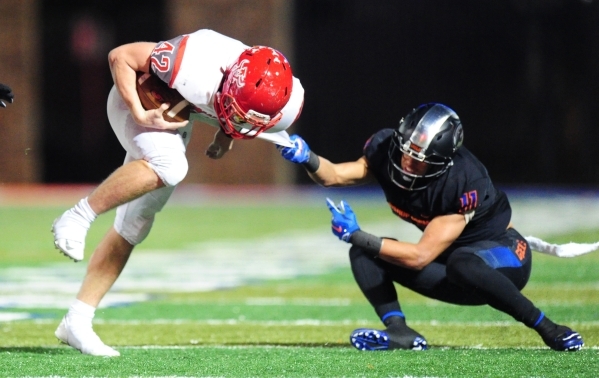 Arbor View fullback Andrew Wagner (42) breaks the tackle of Bishop Gorman free safety Damuzh ...