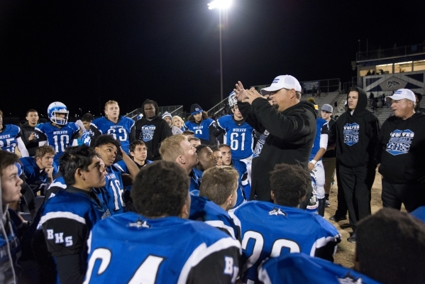 Basic High School football coach Jeff Cahill speaks with his team after defeating Silverado ...