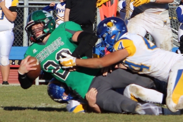 Moapa Valley´s Josh Lyon (4) tackles Churchill County running back Cade Vercellotti during ...