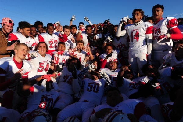 Liberty players hoist the Sunrise Region trophy after defeating Basic 62-22 during the NIAA ...