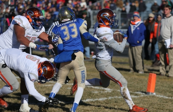 Bishop Gorman‘s Biaggio Ali Walsh (7) rushes for a touchdown past Reed defender Kyeer ...