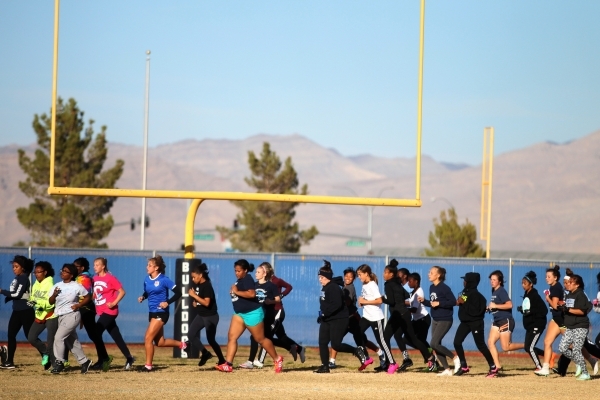 Centennial‘s girls flag football team runs during a practice at Centennial High School ...