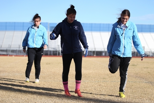 Centennial‘s Courtney Reeves, from left, Ashley Marshall and Cienna Mendez warm up dur ...