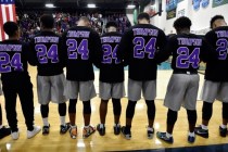Members of the Canyon Springs basketball game bow their heads wearing the number 24 jersey h ...
