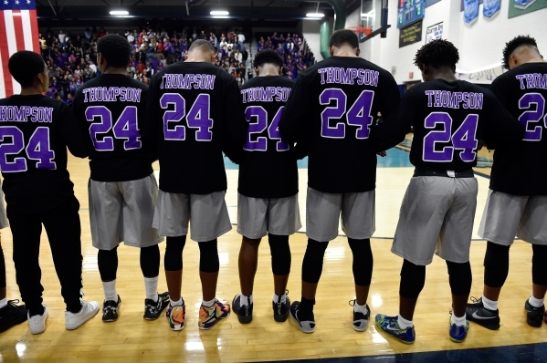 Members of the Canyon Springs basketball game bow their heads wearing the number 24 jersey h ...