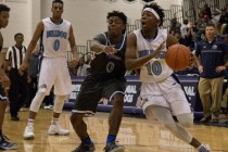 Centennial‘s Isaiah Banks (10) works the ball around Desert Pines‘ Curtis Hender ...