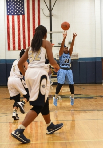 Canyon Springs Keajanae Haley (13) shoots the ball against Cheyenne‘s defense during t ...