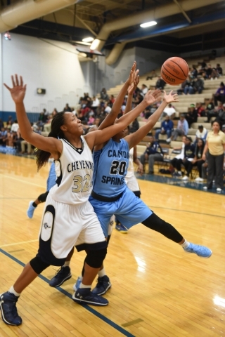 Cheyenne‘s Da‘vione Lomax (32) and Canyon Springs Alexia Thrower (20) fight for ...