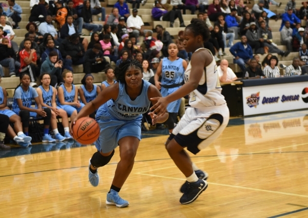 Canyon Springs Destini Hunter (10) drives by Cheyenne‘s Ejanae Coopwood (22) during th ...