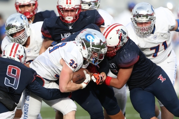 Bishop Gorman‘s Jonathan Shumaker (33) runs the ball against Liberty in the Division I ...