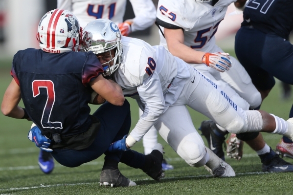 Bishop Gorman‘s Palaie Gaoteote (10) tackles Liberty‘s Ethan Dedeaux (2) in the ...