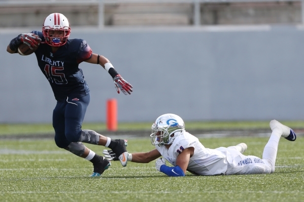 Liberty‘s Stephon Stowers (15) runs the ball against Bishop Gorman in the Division I s ...