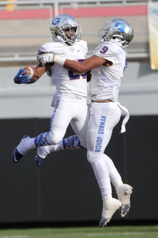Bishop Gorman‘s Tyjon Lindsey (25) celebrates his touchdown with Brevin Jordan (9) aga ...