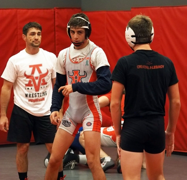 Coach Rusty Marchello, left, watches as wrestlers Lawrence Vigil, center, and Ryder Marchell ...