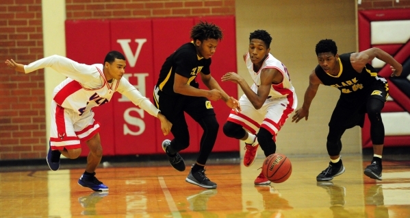 Clark Chargers guard Keyshaun Webb, middle, steals the ball from Valley Vikings guard Shakor ...