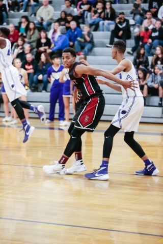 Desert Oasis senior Aamondae Coleman (5) blocks Durango Senior Michael Diggins (2) during a ...