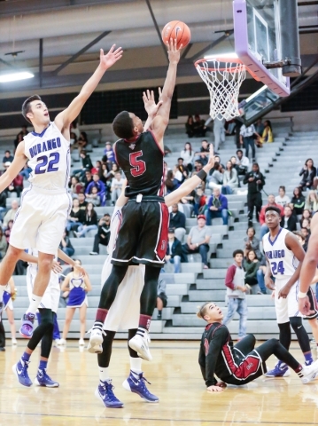 Desert Oasis senior forward Aamondae Coleman (5) jumps for a shot as Durango‘s Senior ...