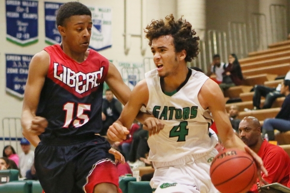 Green Valley‘s Xavier Jarvis, right, is defended by Liberty‘s Cameron Burist dur ...