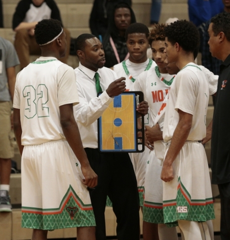Mojave Rattlers head coach Colin Darfour, center, gives some last minute instructions to his ...