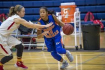 Aja Phoumiphat (10) of the Bishop Gorman Lady Gaels drives to the basket against the Castle ...