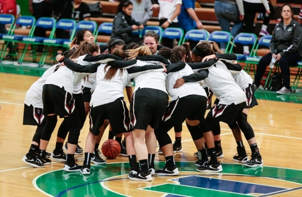 Desert Oasis players rally prior to the start of the basketball game against Green Valley at ...