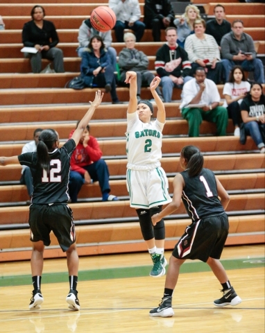 Green Valley senior Gwen Garcia (2) attempts a shot from the three point line, while Desert ...