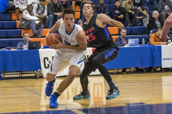 Bishop Gorman center Zach Collins (12) drives to the basket while being defended by Timpview ...