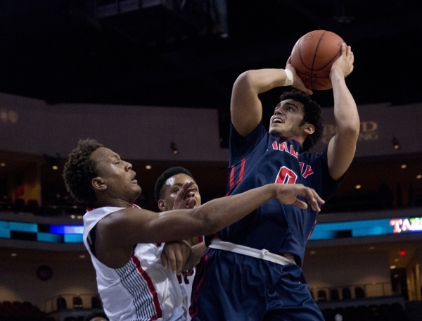 Findlay Prep‘s Markus Howard (0) attempts to put a shot over Victory Prep‘s John ...