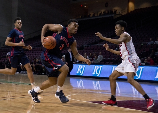 Findlay Prep‘s Carlos Johnson (3) advances the ball as Victory Prep‘s Michael Ki ...