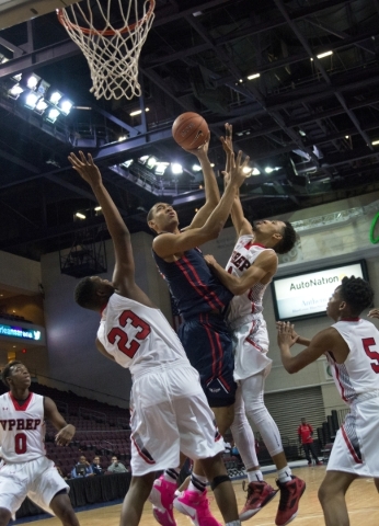 Findlay Prep‘s Tristan Clark (12) takes the ball to the net while being defended by Vi ...