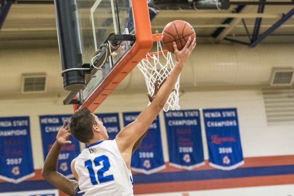 Bishop Gorman center Zach Collins (12) lays up the ball against Overland, Colo., during the ...