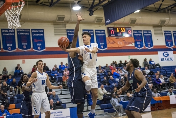 Bishop Gorman guard Chase Nomaaea (1) lays up the ball against Overland, Colo., during the c ...