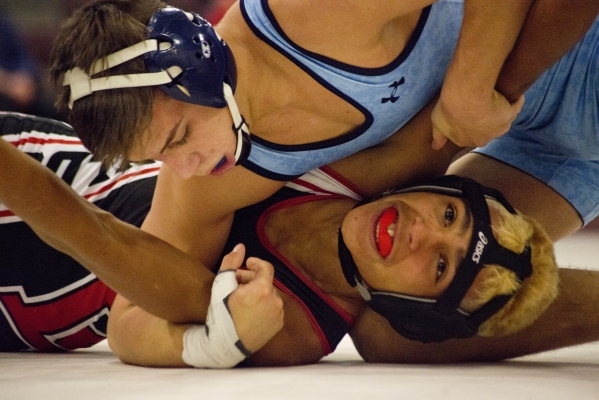 Centennial&lsquo;s Nico Antuna, top, wrestles Las Vegas&lsquo; Aaron Najera during a quad me ...